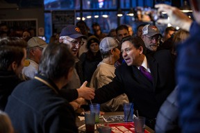 Republican presidential candidate Florida Gov. Ron DeSantis, right, greets supporters following a campaign event at Jerseys Pub and Grub in Cedar Rapids, Iowa, Monday, Jan. 15, 2024.