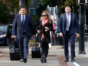 Tamara Lich, middle, walks to the Ottawa courthouse in October with her lawyer, Lawrence Greenspon, left. File photo