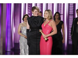 This image released by CBS shows co-director Greta Gerwig, left, and actor Margot Robbie accepting the award for best cinematic and box office achievement for the film "Barbie" during the 81st Annual Golden Globe Awards in Beverly Hills, Calif., on Sunday, Jan. 7, 2024.