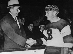 Ace Bailey, left, shakes hands with the Bruins' Eddie Shore at a benefit game held in the Leafs star's honour.