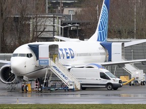 A person walks past a Boeing 737 MAX 8 for United Airlines parked at Renton Municipal Airport adjacent to Boeing's factory in Renton, Washington, on Jan. 25, 2024.