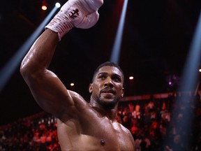 Britain's Anthony Joshua celebrates after defeating Sweden's Otto Wallin during their heavyweight boxing match at the Kingdom Arena in Riyadh on Dec. 23, 2023.