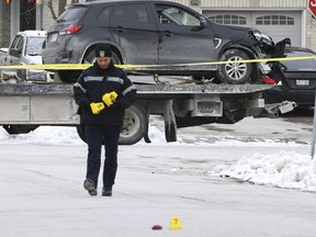 A 29-year-old man was shot to death in his black Mitsubishi SUV in Brampton on Thursday, Jan. 18, 2024. (Pictured) The SUV is transported from the crime scene while Peel Regional Police investigate on Friday Jan. 19, 2024.
