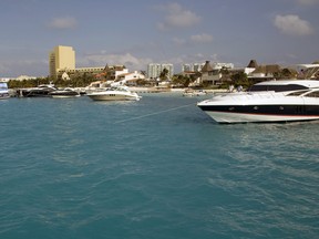 Boats sit docked on the water in Cancun, Mexico, on Saturday, April 3, 2010.