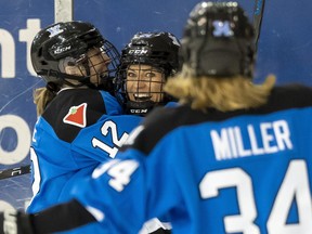 Toronto's Natalie Spooner (24) celebrates with teammates Allie Munroe (12) and Hannah Miller (34) after scoring against New York during second-period PWHL action in Toronto on Friday, Jan. 26, 2024.