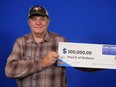 Paul Dutcher holds his $100,000 cheque after winning on the Dec. 30, 2023 Lotto 6/49 draw.