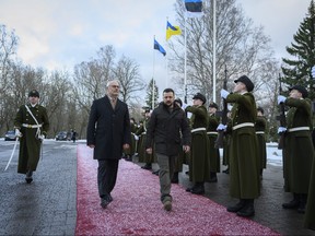 In this photo provided by the Office of the President of the Republic of Estonia, Estonia's President Alar Karis, centre, and Ukrainian President Volodymyr Zelenskyy, centre right, attend a welcoming ceremony, in Tallinn, Estonia, Thursday, Jan.11, 2024.