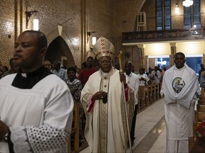 Archbishop of Kinshasa Fridolin Ambongo Besungu (centre) arrives for a Christmas Mass at our Lady of the Congo Cathedral in Kinshasa on Dec. 24, 2023.