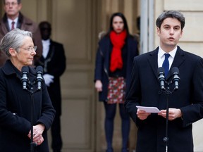 Newly appointed prime minister Gabriel Attal (right) delivers a speech next to outgoing prime minister Elisabeth Borne during the handover ceremony at the Hotel Matignon in Paris, on Jan. 9, 2024.