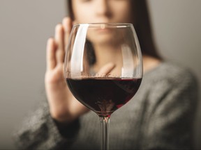 A young person turns down a glass of wine in this file photo.