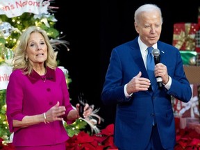 US President Joe Biden speaks alongside First Lady Jill Biden during a holiday visit to patients and families at Childrens National Hospital in Washington, D.C.