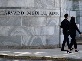 Pedestrians walk toward Harvard Medical School in Boston.