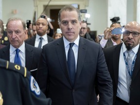 Hunter Biden, U.S. President Joe Biden's son, accompanied by his attorney Abbe Lowell, left, leaves a House Oversight Committee hearing as Republicans are taking the first step toward holding him in contempt of Congress, Wednesday, Jan. 10, 2024, on Capitol Hill in Washington.