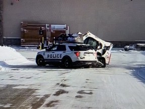 A skid-steer loader hits a police vehicle outside a Home Depot in Lincoln, Neb. in a screenshot from video.