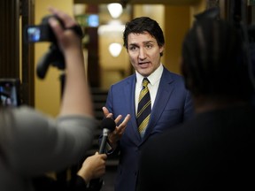 Prime Minister Justin Trudeau speaks to reporters in the foyer of the House of Commons on Parliament Hill in Ottawa on Wednesday, Dec. 13, 2023.