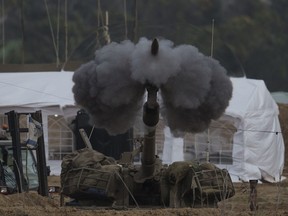 An Israeli mobile artillery unit fires a shell