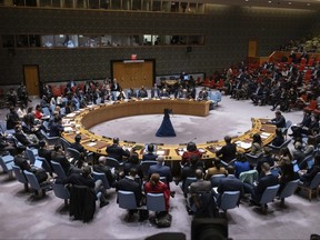 People gather during the Security Council meeting at United Nations headquarters, Friday, Dec. 22, 2023.