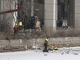 Emergency crews work to retrieve a car that crashed through the ice into the Keating Channel in Toronto on Saturday Jan. 20, 2024. Toronto Fire Services says their crews were unable to rescue a person from Lake Ontario after a vehicle crashed through the ice along the downtown waterfront.