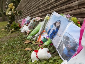 Photos of Alexandra Stemp and a cross were part of a memorial near the Riverside Drive-Wonderland Road intersection in London on Dec. 6, 2021. Stemp died after being struck by an SUV that jumped the curb and drove along the sidewalk. Mike Hensen/ The London Free Press
