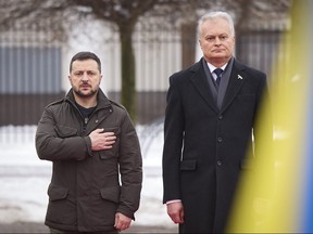 In this photo provided by the Ukrainian Presidential Press Office, Lithuania's President Gitanas Nauseda, right, and Ukrainian President Volodymyr Zelenskyy attend a welcoming ceremony in Presidential Courtyard, Vilnius, Lithuania, Jan. 10, 2024.