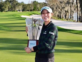 Lydia Ko of New Zealand poses with the trophy after winning the Hilton Grand Vacations Tournament of Champions at Lake Nona Golf & Country Club on Jan. 21, 2024 in Orlando, Fla.