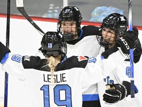 Toronto's Maggie Connors (22) celebrates with teammates Rebecca Leslie (19) and Kali Flanagan (6) after scoring against Montreal during third period PWHL hockey action in Montreal, Saturday, Jan. 20, 2024.