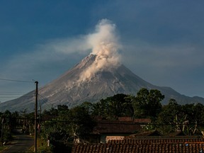 In this file photo taken on Aug. 9, 2023, Mount Merapi spews smoke during an effusive eruption as seen from Wonokerto village, Yogyakarta.