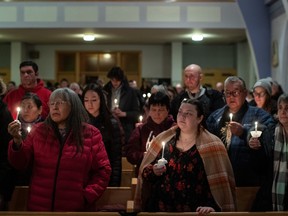 Community members gather and hold a vigil for the six people killed in a plane crash, in Fort Smith, Northwest Territories, on Wednesday, Jan. 24, 2024.