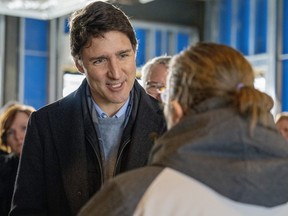 Prime Minister Justin Trudeau speaks to a community member at a housing announcement in Guelph, Ont., on Friday Jan. 12, 2024.