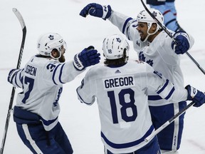 Maple Leafs forward Ryan Reaves (right) celebrates his goal with defenceman Timothy Liljegren (left), Noah Gregor (centre) against the Jets during first period NHL action in Winnipeg, Saturday, Jan. 27, 2024.