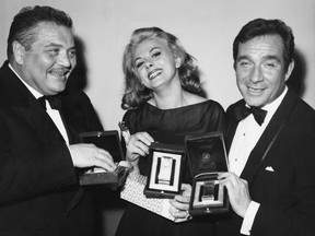 From left to right, actors Folco Lulli, Sandra Milo and Ugo Tognazzi receive Nastri d'Argento (Silver Ribbons) at the Italian National Syndicate of Film Journalists awards in Rome, Italy, April 6, 1964. Lulli and Milo received Best Supporting Actor and Actress respectively, and Tognazzi won Best Actor
