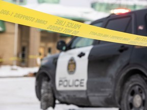 John Costello Catholic School is seen cordoned off by police tape as Calgary police investigate a domestic homicide outside of the school on Tuesday, January 16, 2024.
