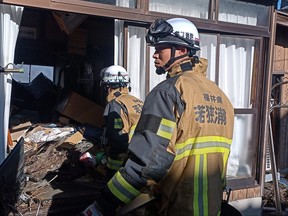 Members of a rescue team search houses for survivors in the city of Suzu, Ishikawa prefecture on Jan. 4, 2024, after a major 7.5 magnitude earthquake struck the Noto region in Ishikawa prefecture on New Year's Day.