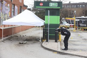 Toronto Police Forensic officers pick up a multitude of fragments and evidence from the inner debris field of a bomb blast that happened at a drive-thru TD Bank ATM at St. Clair Ave. E. and O'Connor Dr. that occurred on Sunday morning on Monday Jan. 29, 2024.