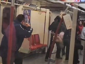Two men about to fight on TTC subway car.