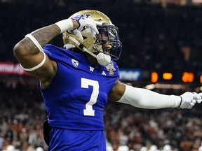 Washington cornerback Jabbar Muhammad (1) celebrates a recovered fumble against Texas during the second half of the Sugar Bowl CFP NCAA semifinal college football game, Monday, Jan. 1, 2024, in New Orleans.