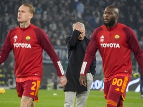 Roma's Romelu Lukaku, right and Rick Karsdorp walks by head coach Jose Mourinho during the warm up ahead of the quarterfinal Italian Cup soccer match between Lazio and Roma at Rome's Olympic Stadium, Wednesday, Jan. 10, 2024.