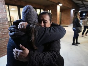 Dora Mendoza, right, is hugged by a friend as she leaves a meeting where Attorney General Merrick Garland shared a report on the findings of an investigation into the 2022 school shooting at Robb Elementary School, Wednesday, Jan. 17, 2024, in Uvalde, Texas. Mendoza is the grandmother of 10-year-old Amerie Jo Garza who was killed in the shooting.
