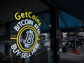 A sign for a Bitcoin automated teller machine (ATM) at a gas station in Washington, DC, US, on Thursday, Jan. 19, 2023. Bitcoin steadied after snapping a rare 14-day winning streak as a mood of caution supplanted the risk appetite that drove up a variety of assets at the start of the year. Photographer: Al Drago/Bloomberg