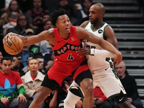 Toronto Raptors forward Scottie Barnes (4) protects the ball from Milwaukee Bucks forward Khris Middleton (22) during first half NBA basketball action in Toronto on Wednesday, Nov. 1, 2023. Raptors star Barnes has the top-selling NBA jersey in Canada.