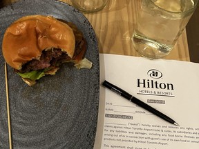 Burger with a waiver and pen next to it.
