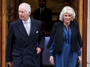 King Charles III smiles as he departs with Queen Camilla after receiving treatment for an enlarged prostate at The London Clinic on Jan. 29, 2024 in London.