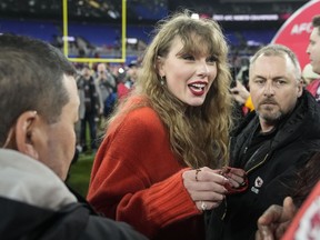 Taylor Swift speaks with people on the field after an AFC Championship NFL football game between the Baltimore Ravens and the Kansas City Chiefs, Sunday, Jan. 28, 2024, in Baltimore. The Kansas City Chiefs won 17-10.