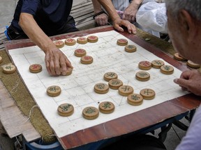 Residents play Chinese chess games