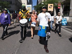 People participate in a climate protest in Toronto, on Saturday, Sept. 16, 2023.