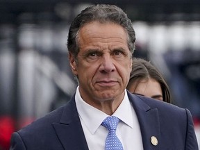 FILE - New York Gov. Andrew Cuomo prepares to board a helicopter after announcing his resignation, Aug. 10, 2021, in New York. On Friday, Jan. 26, 2024, the U.S. Justice Department reached a settlement with the state of New York to resolve a sexual harassment investigation of former Gov. Cuomo, confirming allegations from the damaging misconduct probe that led to the Democrat's resignation.