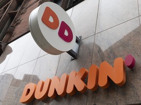 The Dunkin' logo is seen on a storefront, Friday, Oct. 14, 2022, in Boston.
