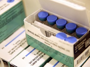 Vials of measles, mumps and rubella vaccine sit in a cooler