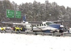 Emergency personnel investigate a small plane