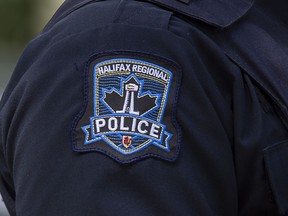 A Halifax Regional Police emblem is seen as police officers attend a murder scene in Halifax on Thursday, July 2, 2020.